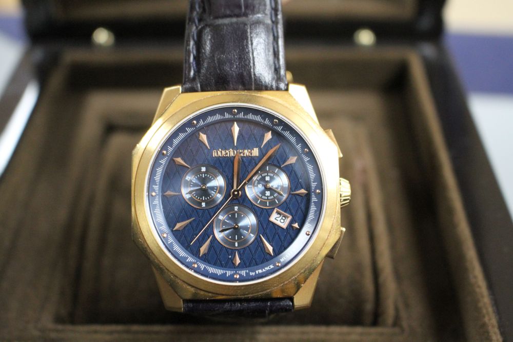 A gentlemans gilt steel Robert Cavalli quartz chronograph wrist watch, with box.